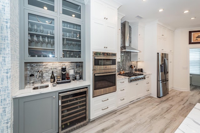 2226 Folly Rd, Charleston, SC 29412 - indoor wet bar with wine cooler, wall chimney exhaust hood, stainless steel appliances, decorative backsplash, and recessed lighting