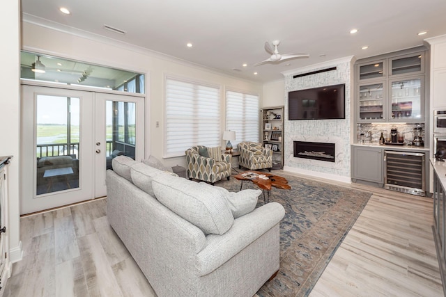 2226 Folly Rd, Charleston, SC 29412 - living area with beverage cooler, french doors, crown molding, healthy amount of natural light, and a ceiling fan