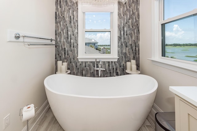 2226 Folly Rd, Charleston, SC 29412 - full bath featuring a freestanding tub, plenty of natural light, and vanity