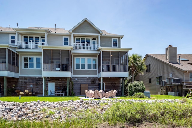 2226 Folly Rd, Charleston, SC 29412 - rear view of house featuring a sunroom, brick siding, and a balcony