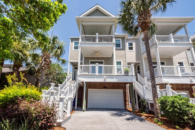 2226 Folly Rd, Charleston, SC 29412 - coastal inspired home with stairway, driveway, a balcony, a garage, and ceiling fan