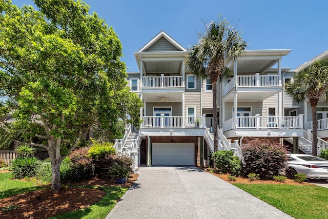 2226 Folly Rd, Charleston, SC 29412 - coastal home featuring stairs, asphalt driveway, and an attached garage