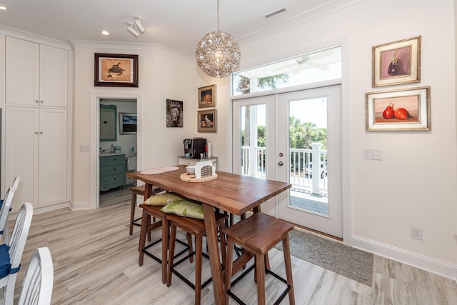 2226 Folly Rd, Charleston, SC 29412 - dining room with french doors, light wood-type flooring, ornamental molding, recessed lighting, and a chandelier