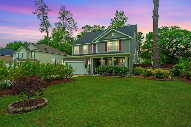 view of front of home featuring a yard and a garage