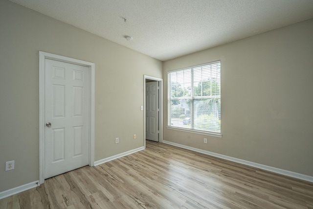 45 Scyamore Ave Unit 623, Charleston, SC 29407 - unfurnished bedroom featuring light wood-style floors and a textured ceiling