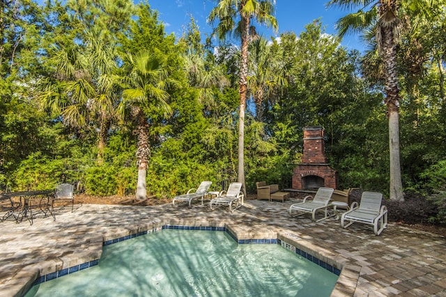 45 Scyamore Ave Unit 623, Charleston, SC 29407 - outdoor pool featuring an outdoor brick fireplace, a patio, and view of wooded area