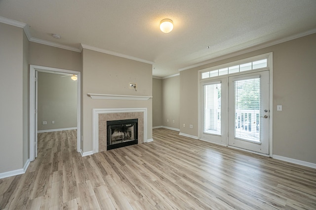 45 Scyamore Ave Unit 623, Charleston, SC 29407 - unfurnished living room with light wood-style flooring, crown molding, a tile fireplace, a textured ceiling, and a ceiling fan
