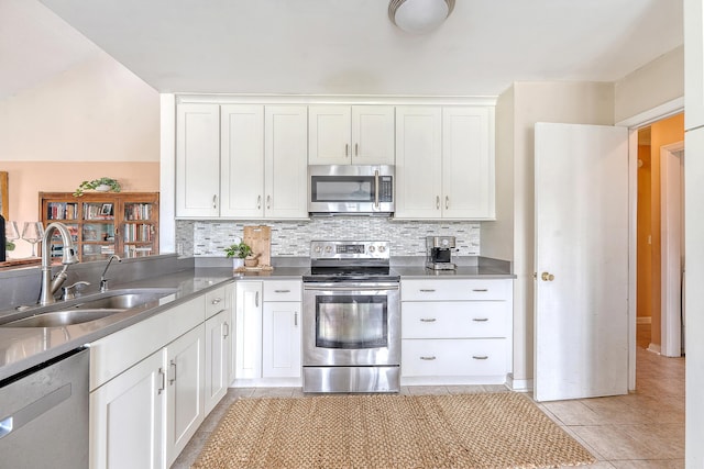 4636 Ashley View Ln, North Charleston, SC 29405 - kitchen featuring appliances with stainless steel finishes, light tile patterned flooring, backsplash, and white cabinets