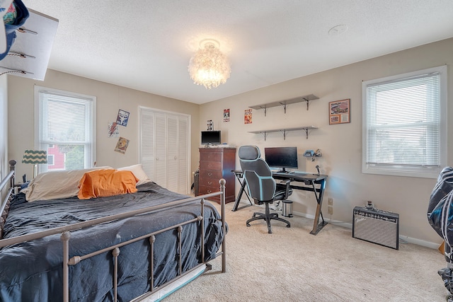4636 Ashley View Ln, North Charleston, SC 29405 - bedroom with multiple windows, light carpet, a closet, and a chandelier