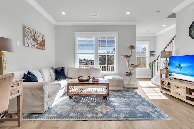 living room featuring light wood-type flooring and ornamental molding