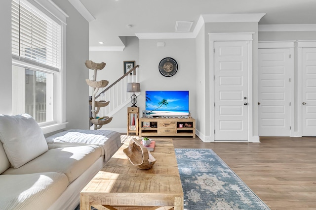 living room with hardwood / wood-style flooring and ornamental molding