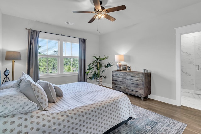 bedroom featuring connected bathroom, ceiling fan, and hardwood / wood-style floors