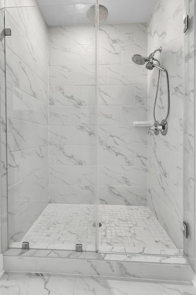 bathroom with a shower with shower door