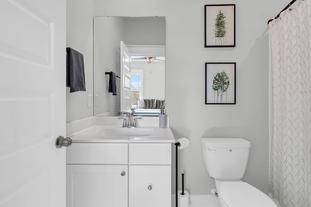 bathroom with ceiling fan, toilet, and vanity