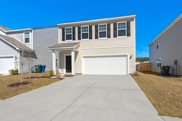 view of front of house with a garage, concrete driveway, and fence