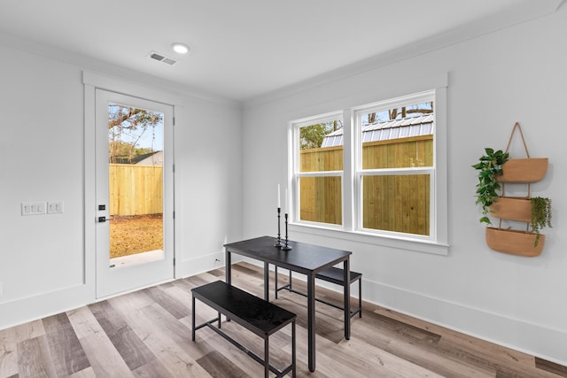 dining space featuring plenty of natural light, wood finished floors, visible vents, and baseboards