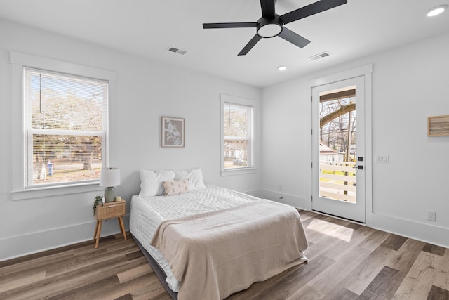 bedroom featuring baseboards, recessed lighting, wood finished floors, and access to exterior