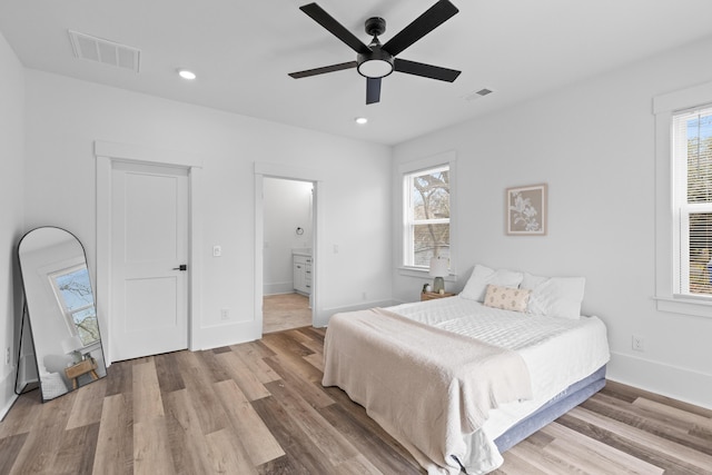 bedroom featuring recessed lighting, visible vents, baseboards, and wood finished floors