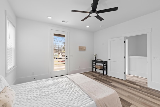 bedroom with access to exterior, visible vents, wood finished floors, and recessed lighting