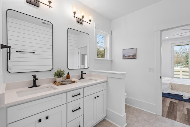 full bathroom with ensuite bath, plenty of natural light, and a sink