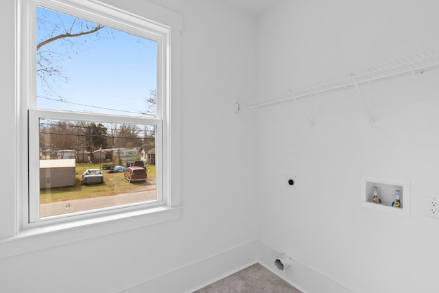 clothes washing area featuring baseboards, laundry area, hookup for a washing machine, and hookup for an electric dryer