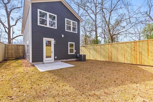 back of house featuring a patio, central AC unit, a lawn, and a fenced backyard