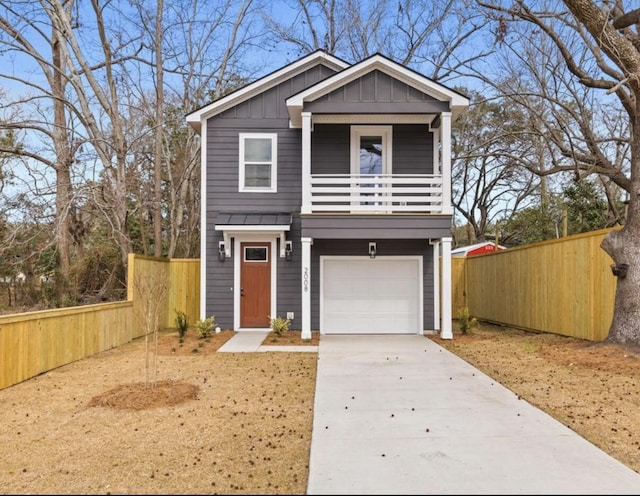 view of front of house with concrete driveway, board and batten siding, fence, and a balcony