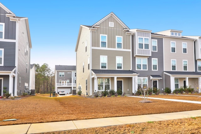 view of front of property with central AC and a front lawn