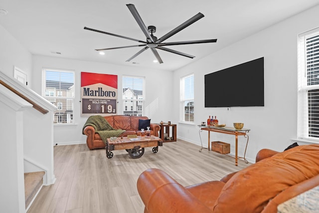 living room featuring ceiling fan and light hardwood / wood-style flooring