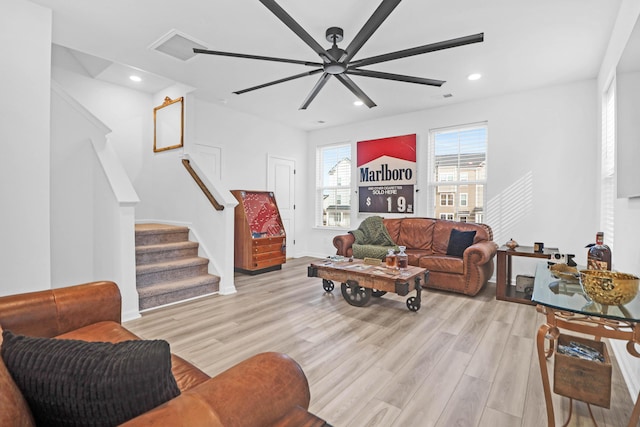 living room featuring ceiling fan and light hardwood / wood-style floors