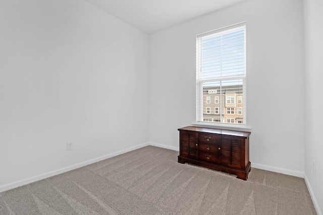 unfurnished room with a wealth of natural light and light carpet