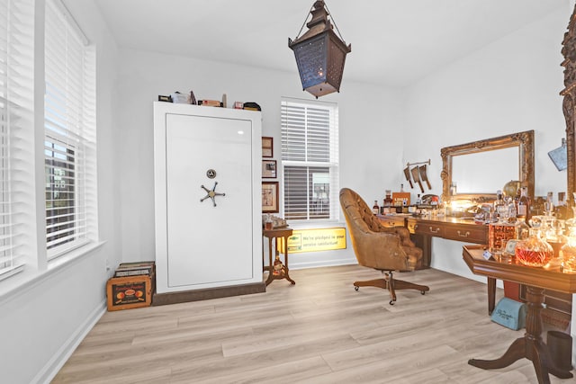 home office with light hardwood / wood-style floors