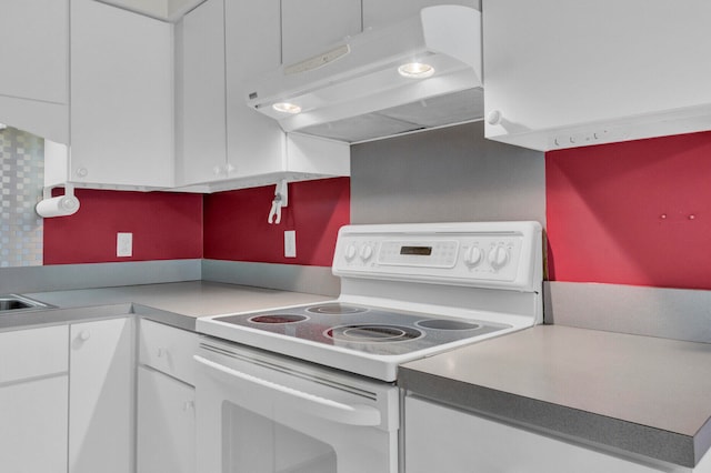 kitchen featuring white cabinetry, decorative backsplash, and white range with electric stovetop