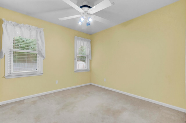 carpeted empty room featuring ceiling fan