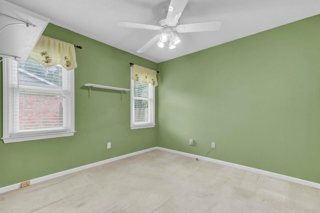 carpeted spare room with ceiling fan