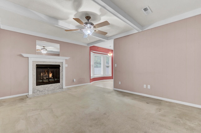 unfurnished living room with a fireplace, beam ceiling, and light carpet