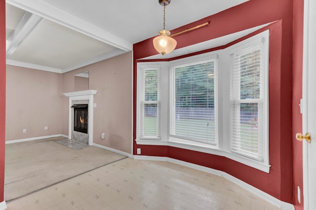 unfurnished living room with a fireplace and beamed ceiling