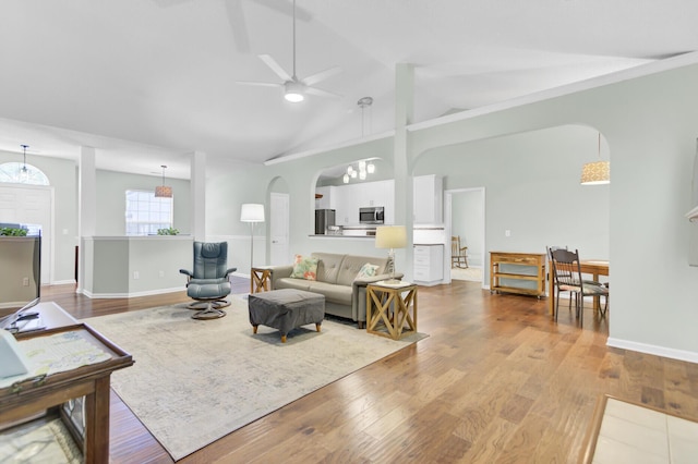 5406 Dwight Dr, North Charleston, SC 29420 - living area with arched walkways, wood finished floors, a ceiling fan, and high vaulted ceiling