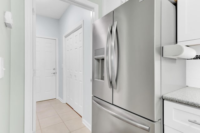 5406 Dwight Dr, North Charleston, SC 29420 - kitchen featuring stainless steel refrigerator with ice dispenser, white cabinets, light tile patterned floors, and light countertops