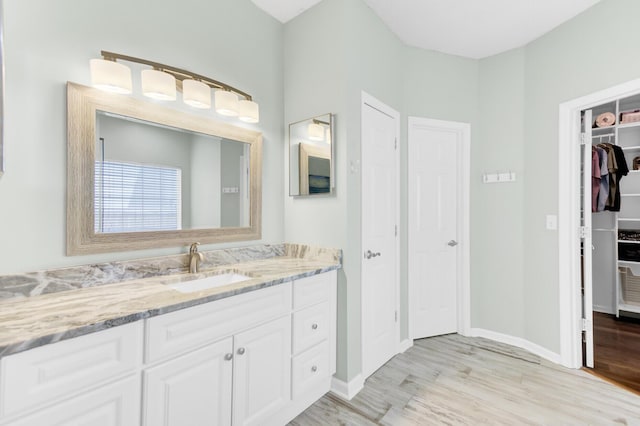 5406 Dwight Dr, North Charleston, SC 29420 - bathroom with vanity, wood finished floors, and a spacious closet