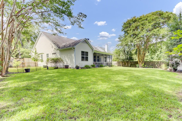 5406 Dwight Dr, North Charleston, SC 29420 - rear view of property featuring a sunroom, a chimney, and a fenced backyard