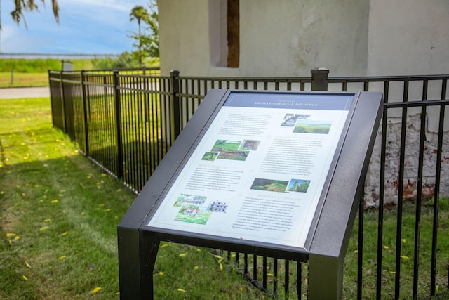 details featuring fence and stucco siding