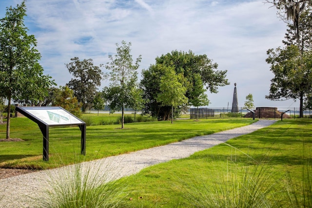 surrounding community featuring a yard and fence