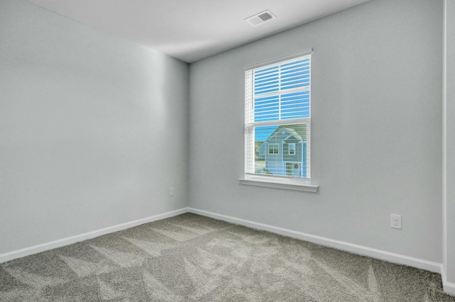 carpeted empty room with baseboards and visible vents