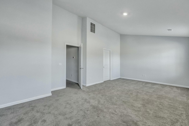 empty room featuring visible vents, high vaulted ceiling, recessed lighting, carpet floors, and baseboards