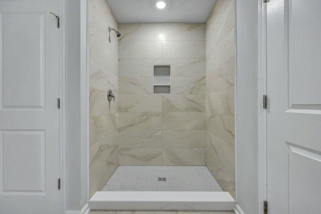 full bath with tiled shower