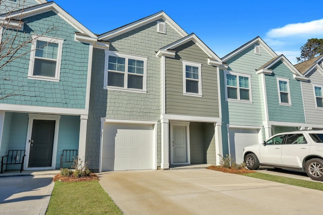 townhome / multi-family property featuring a garage and driveway