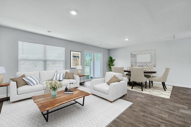 living area featuring visible vents, recessed lighting, baseboards, and wood finished floors