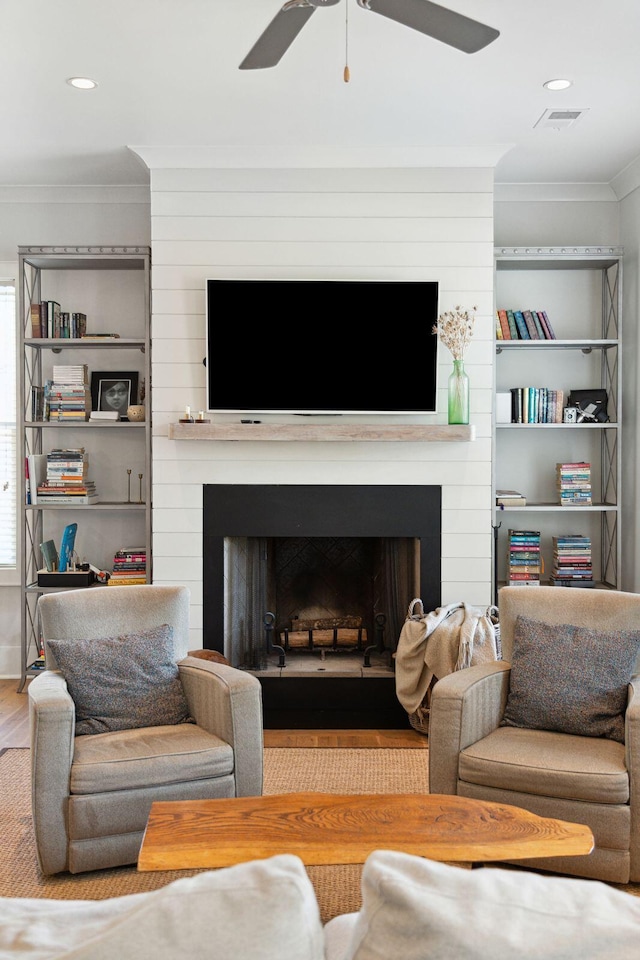 1474 Indian St, Mount Pleasant, SC 29464 - living room with a large fireplace, crown molding, a ceiling fan, wood finished floors, and recessed lighting