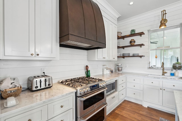1474 Indian St, Mount Pleasant, SC 29464 - kitchen with stainless steel appliances, custom range hood, a sink, white cabinets, and light stone counters